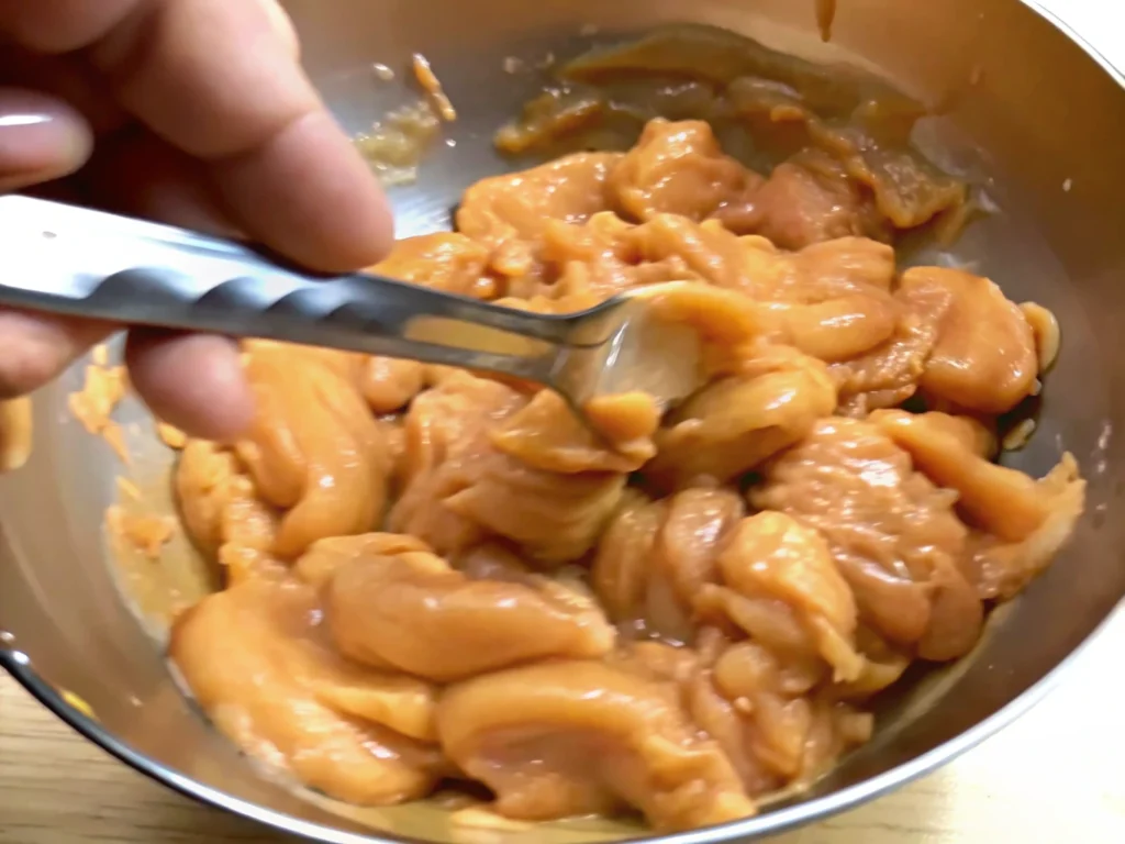 Marinated chicken in a bowl for an authentic Chinese Chicken Stir Fry Recipe.